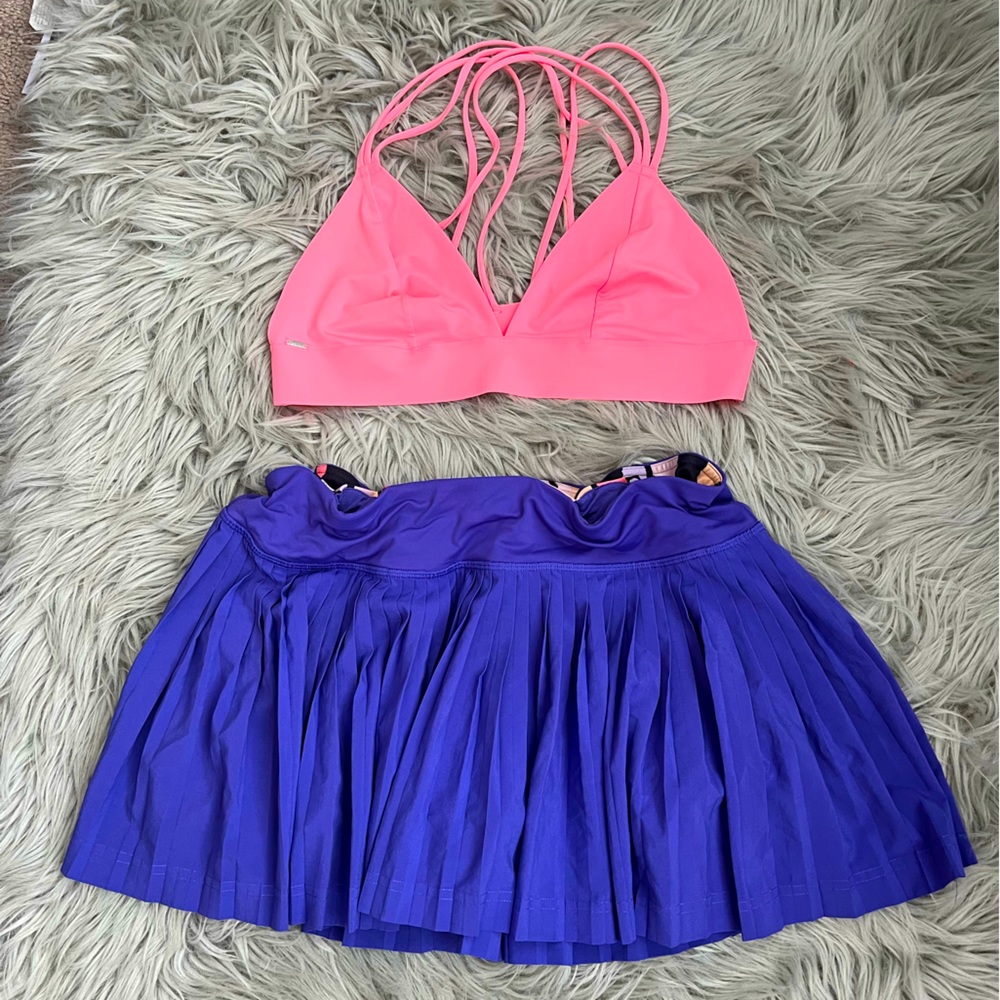 Lululemon purple tennis skirt with zipper pocket and pocket in front.